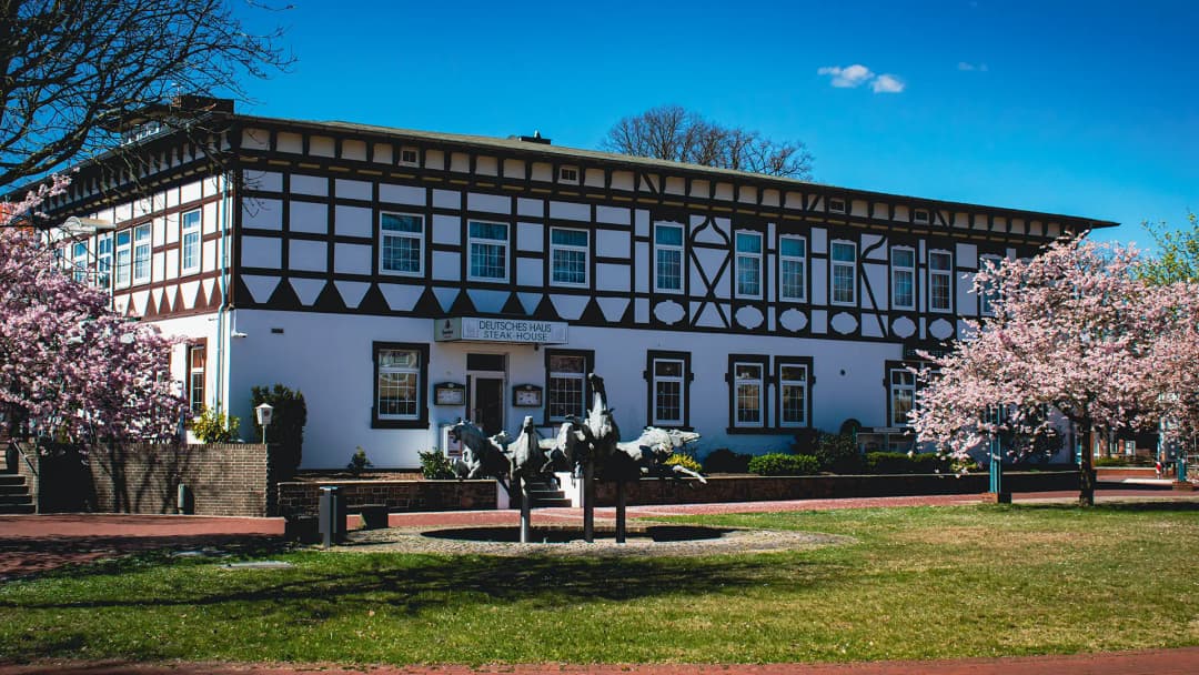 Hotel Deutsches Haus with flowering trees at Friedrich-Heinrich-Platz